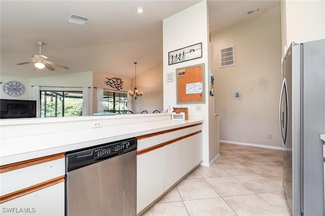 kitchen with light tile patterned floors, hanging light fixtures, stainless steel appliances, white cabinets, and ceiling fan with notable chandelier