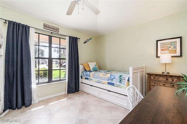 bedroom featuring light tile patterned floors and ceiling fan