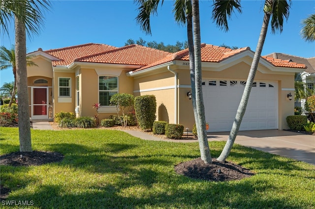 mediterranean / spanish-style house with a garage and a front yard