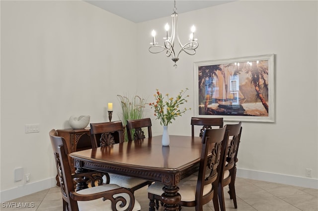 tiled dining room featuring a chandelier