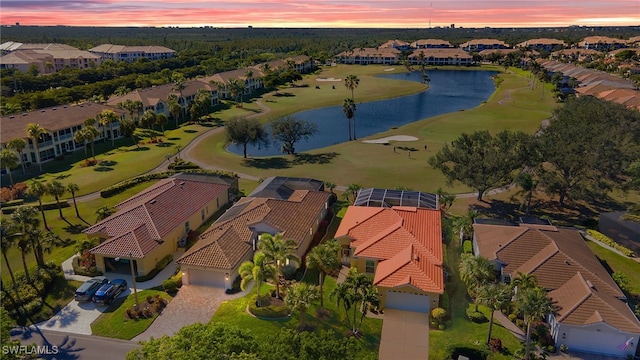 aerial view at dusk with a water view