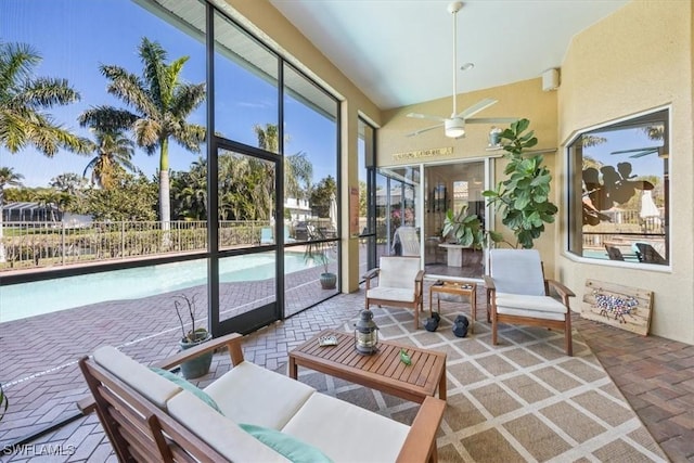 sunroom featuring ceiling fan