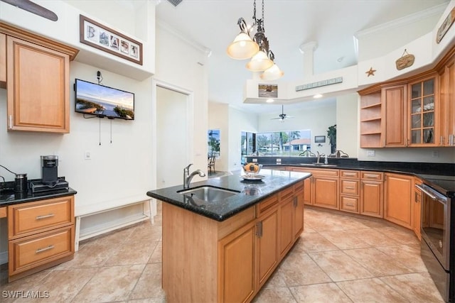 kitchen featuring pendant lighting, stainless steel range with electric stovetop, sink, and a center island with sink