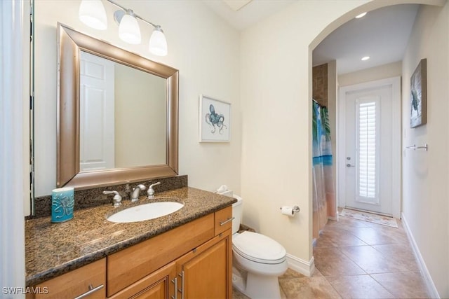 bathroom with vanity, tile patterned flooring, and toilet