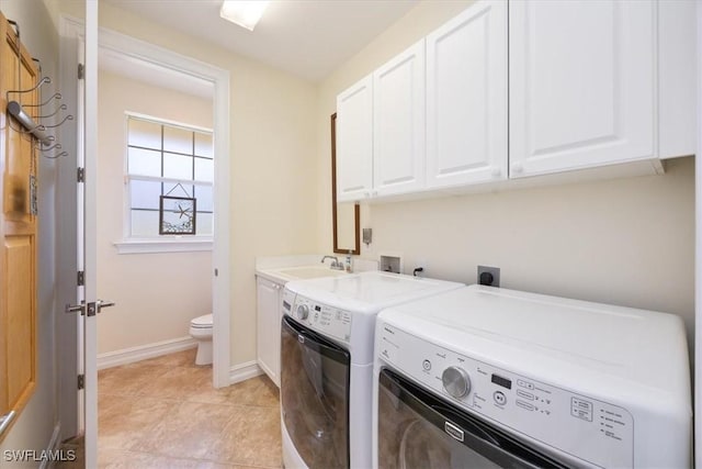 clothes washing area with cabinets, washer and dryer, sink, and light tile patterned floors