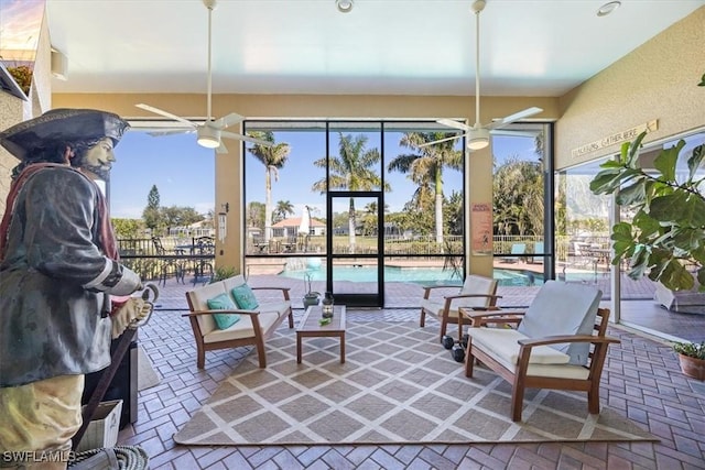 sunroom featuring ceiling fan