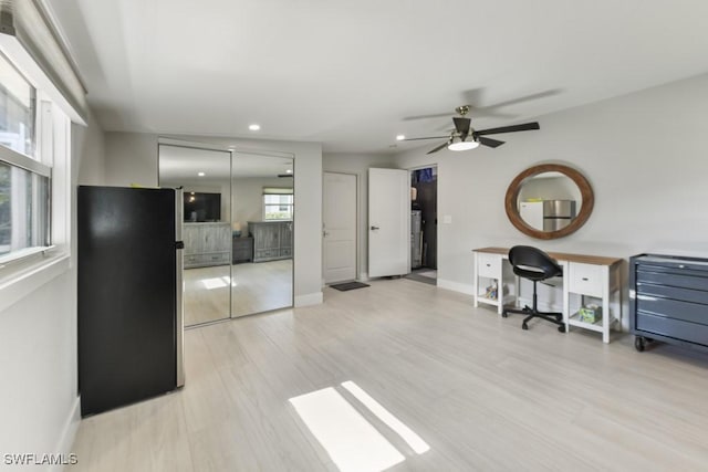 office space with light wood-type flooring and ceiling fan