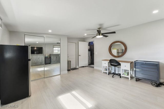 office with light hardwood / wood-style floors and ceiling fan