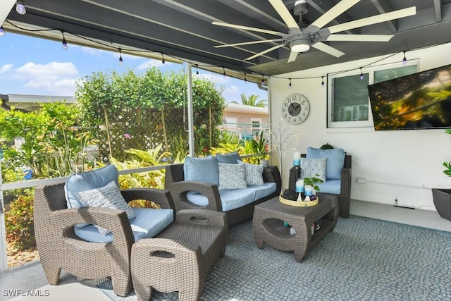 sunroom / solarium featuring ceiling fan and a wealth of natural light