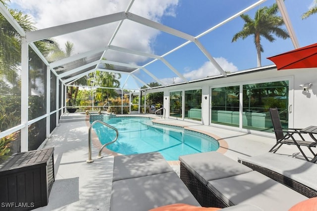 view of swimming pool with a patio and a lanai