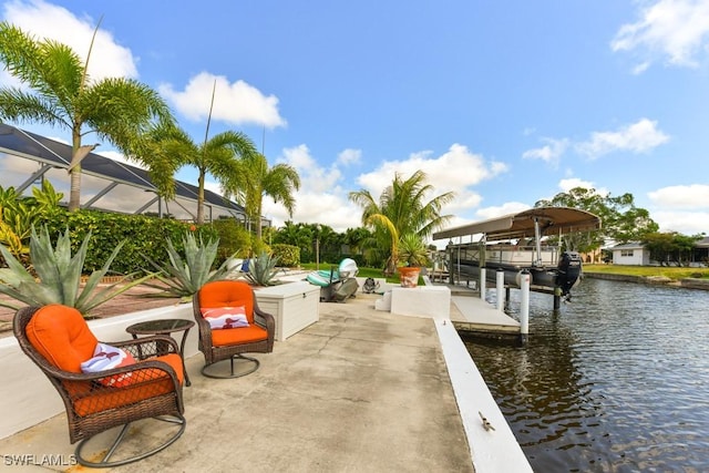 view of patio / terrace with a lanai, a dock, and a water view