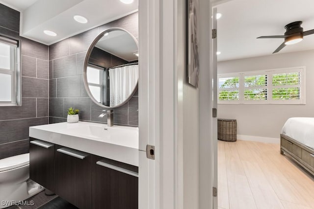 bathroom featuring vanity, a shower with curtain, ceiling fan, toilet, and hardwood / wood-style flooring