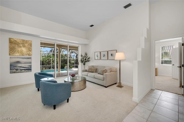 living room featuring light colored carpet and plenty of natural light