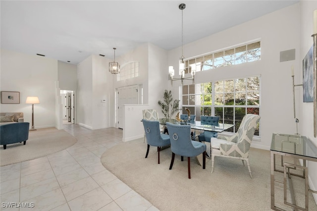 tiled dining space with an inviting chandelier and a towering ceiling