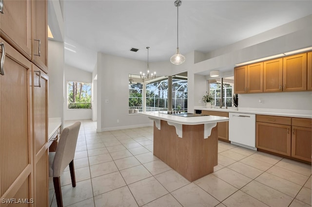 kitchen featuring a notable chandelier, a center island, dishwasher, a kitchen breakfast bar, and pendant lighting