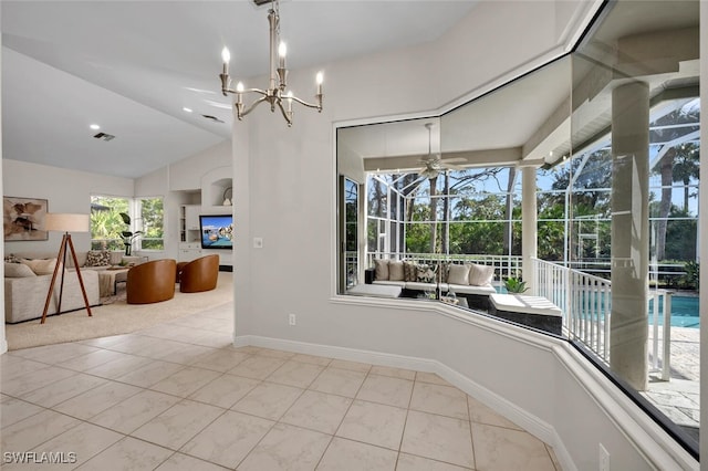 unfurnished dining area featuring ceiling fan with notable chandelier and lofted ceiling