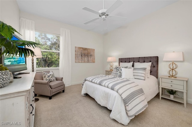 bedroom featuring light carpet and ceiling fan