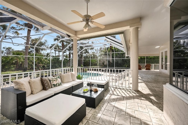 view of patio / terrace with glass enclosure, ceiling fan, and an outdoor hangout area