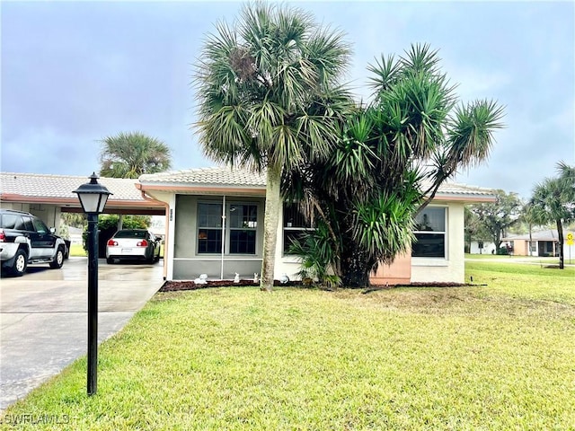 view of front of house with a front yard and a carport