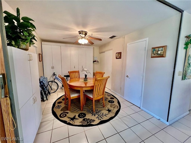 tiled dining room featuring ceiling fan