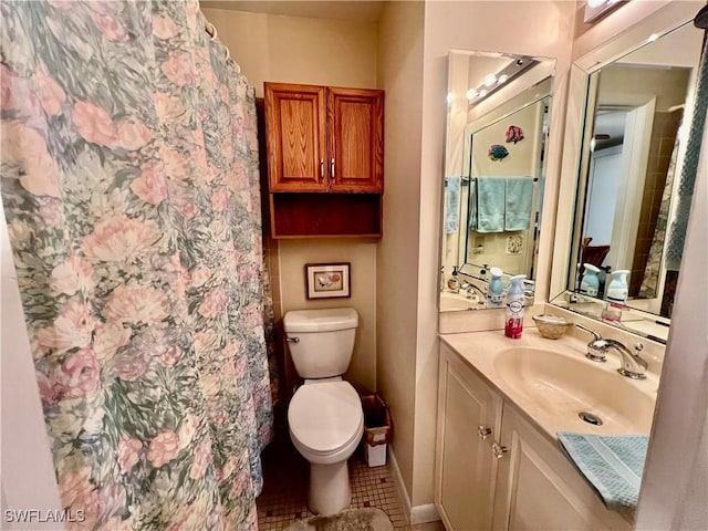 bathroom featuring toilet, tile patterned floors, and vanity