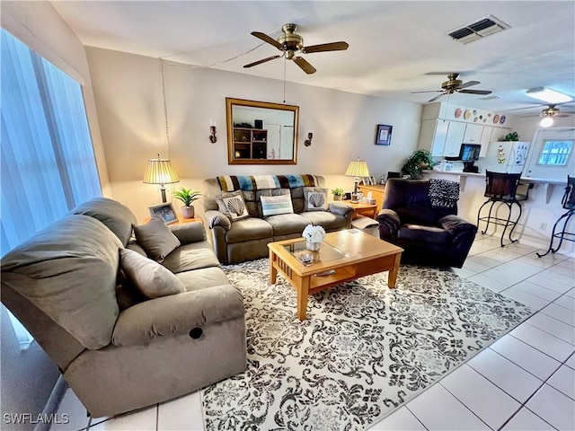 living room featuring plenty of natural light and light tile patterned floors