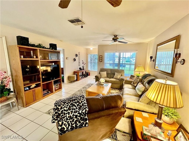 living room featuring ceiling fan and light tile patterned flooring