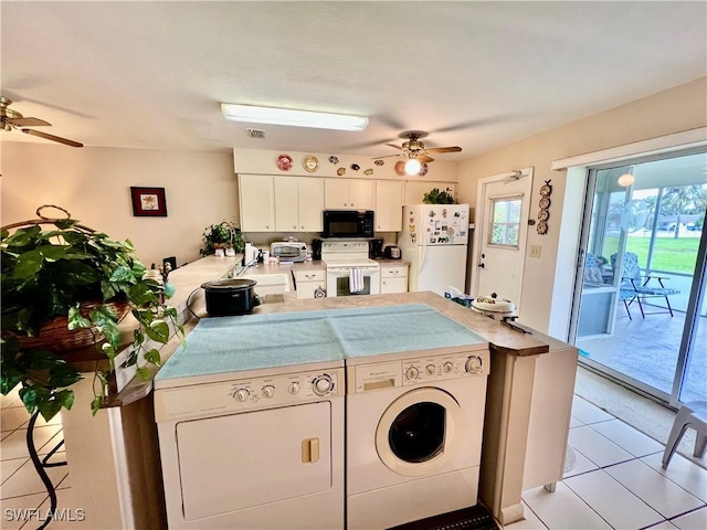 interior space featuring ceiling fan, separate washer and dryer, sink, and light tile patterned flooring