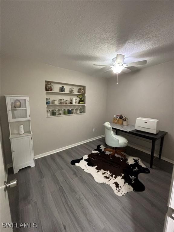 home office with dark wood-type flooring, a textured ceiling, and ceiling fan