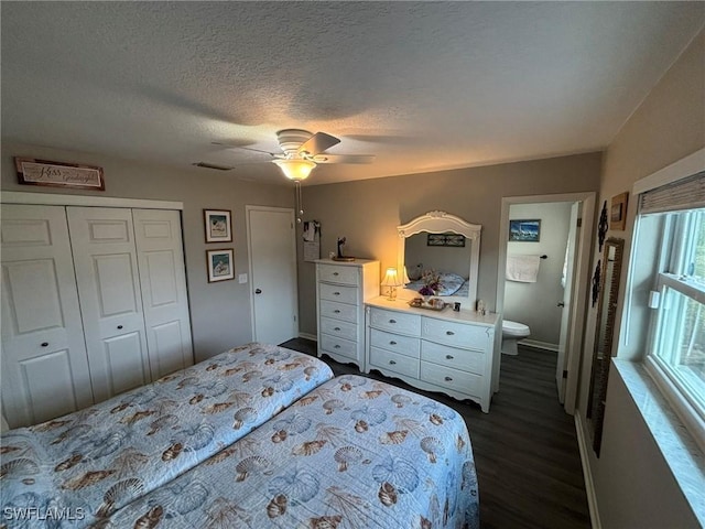 bedroom with ensuite bathroom, ceiling fan, a textured ceiling, dark hardwood / wood-style floors, and a closet