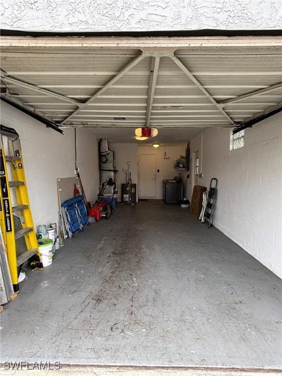 garage featuring a garage door opener and water heater