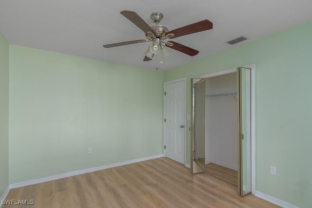 unfurnished bedroom with ceiling fan, a closet, and light wood-type flooring