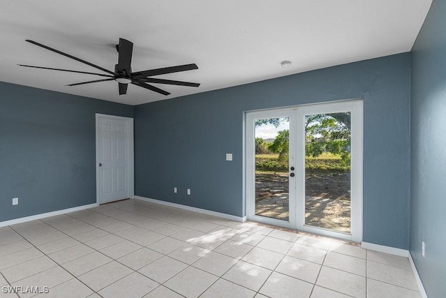 empty room with light tile patterned flooring, ceiling fan, and french doors