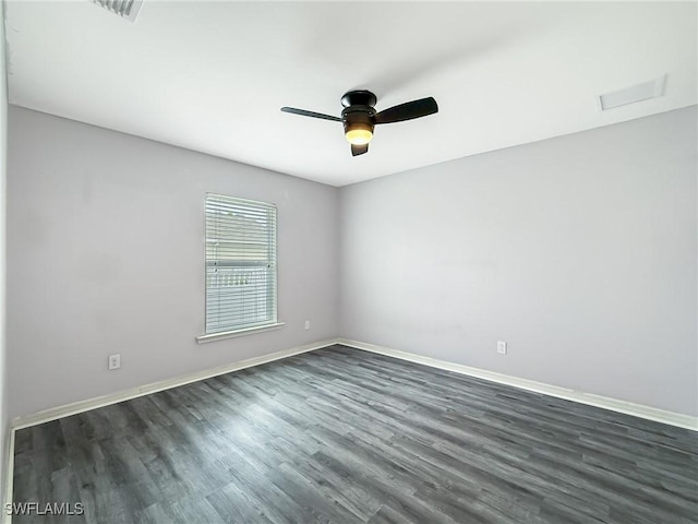 empty room featuring dark wood-type flooring and ceiling fan