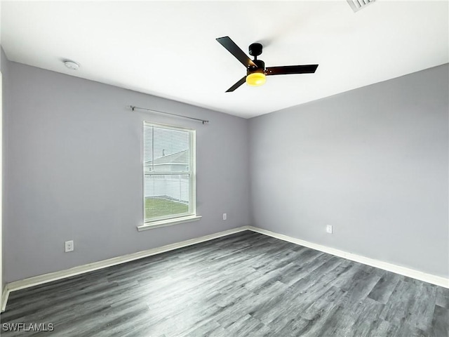 unfurnished room with dark hardwood / wood-style floors and ceiling fan