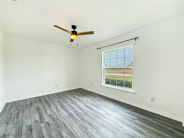 spare room with ceiling fan and wood-type flooring