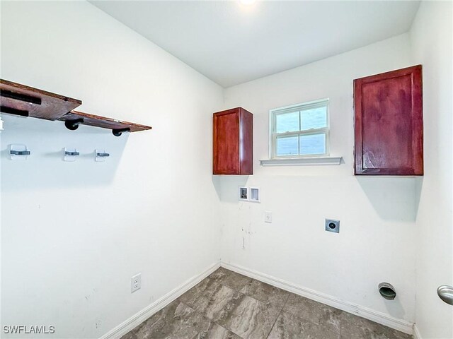 clothes washing area with cabinets, hookup for a washing machine, and hookup for an electric dryer