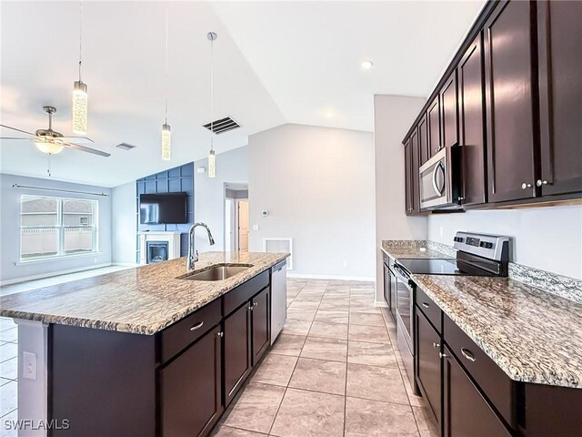 kitchen featuring pendant lighting, sink, appliances with stainless steel finishes, a kitchen island with sink, and dark brown cabinets