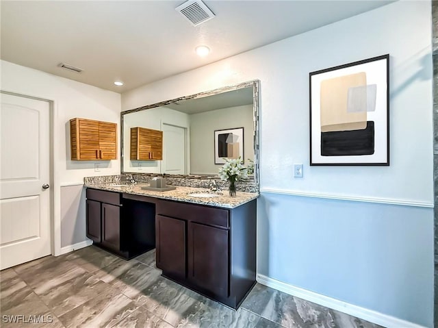 full bath with double vanity, a sink, and visible vents