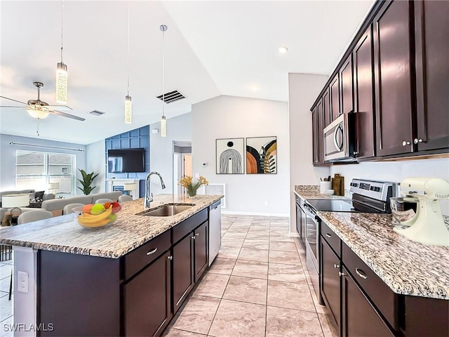 kitchen featuring dark brown cabinetry, visible vents, appliances with stainless steel finishes, hanging light fixtures, and a sink