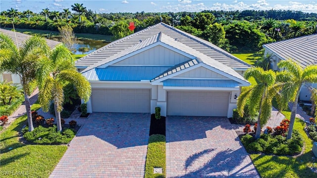 view of front facade with a garage and a water view