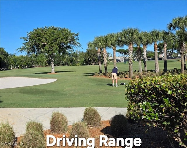 view of property's community with a yard and view of golf course