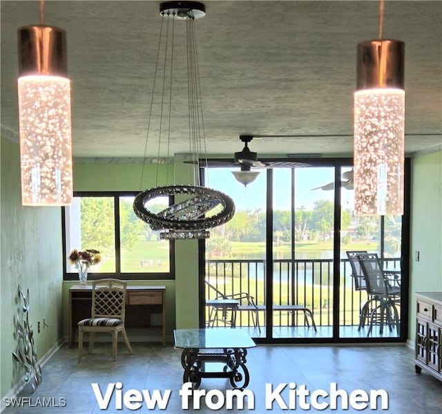 interior space with ceiling fan, plenty of natural light, and floor to ceiling windows