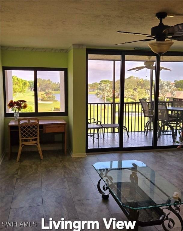 doorway to outside with a healthy amount of sunlight, a ceiling fan, and a textured ceiling