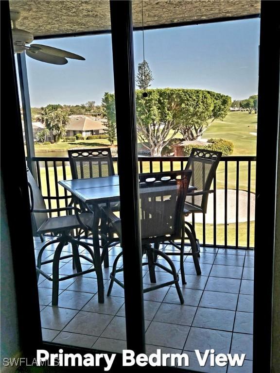 balcony featuring outdoor dining space and a ceiling fan