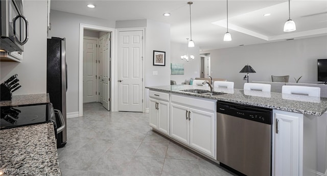 kitchen with sink, dishwasher, light stone countertops, white cabinets, and decorative light fixtures