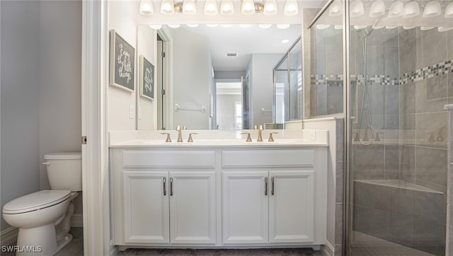 bathroom with walk in shower, vanity, and toilet