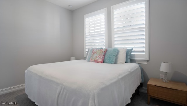 bedroom featuring dark carpet