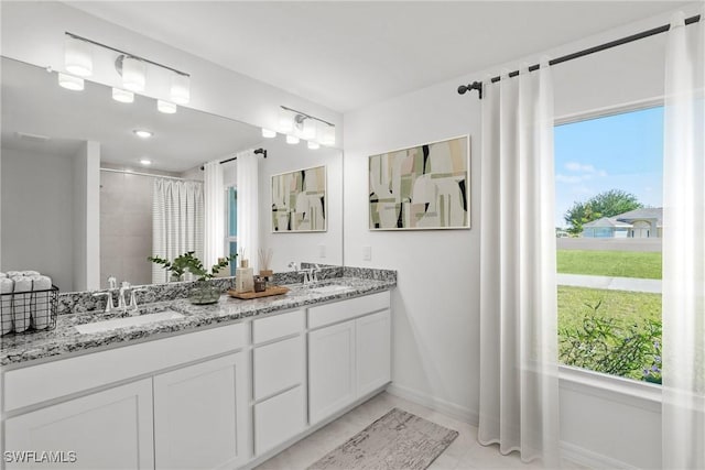 bathroom with vanity, tile patterned floors, and tiled shower