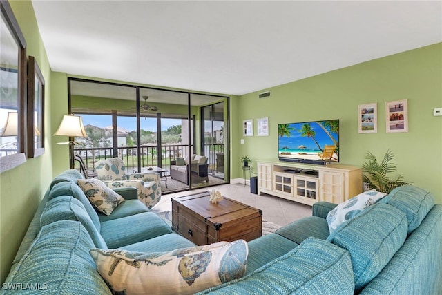 living room with light tile patterned flooring and floor to ceiling windows